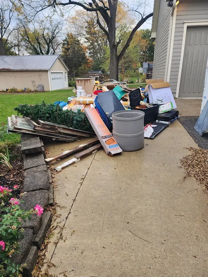 Dumpster being loaded with debris for Residential Dumpster Rental in The Village of Indian Hill